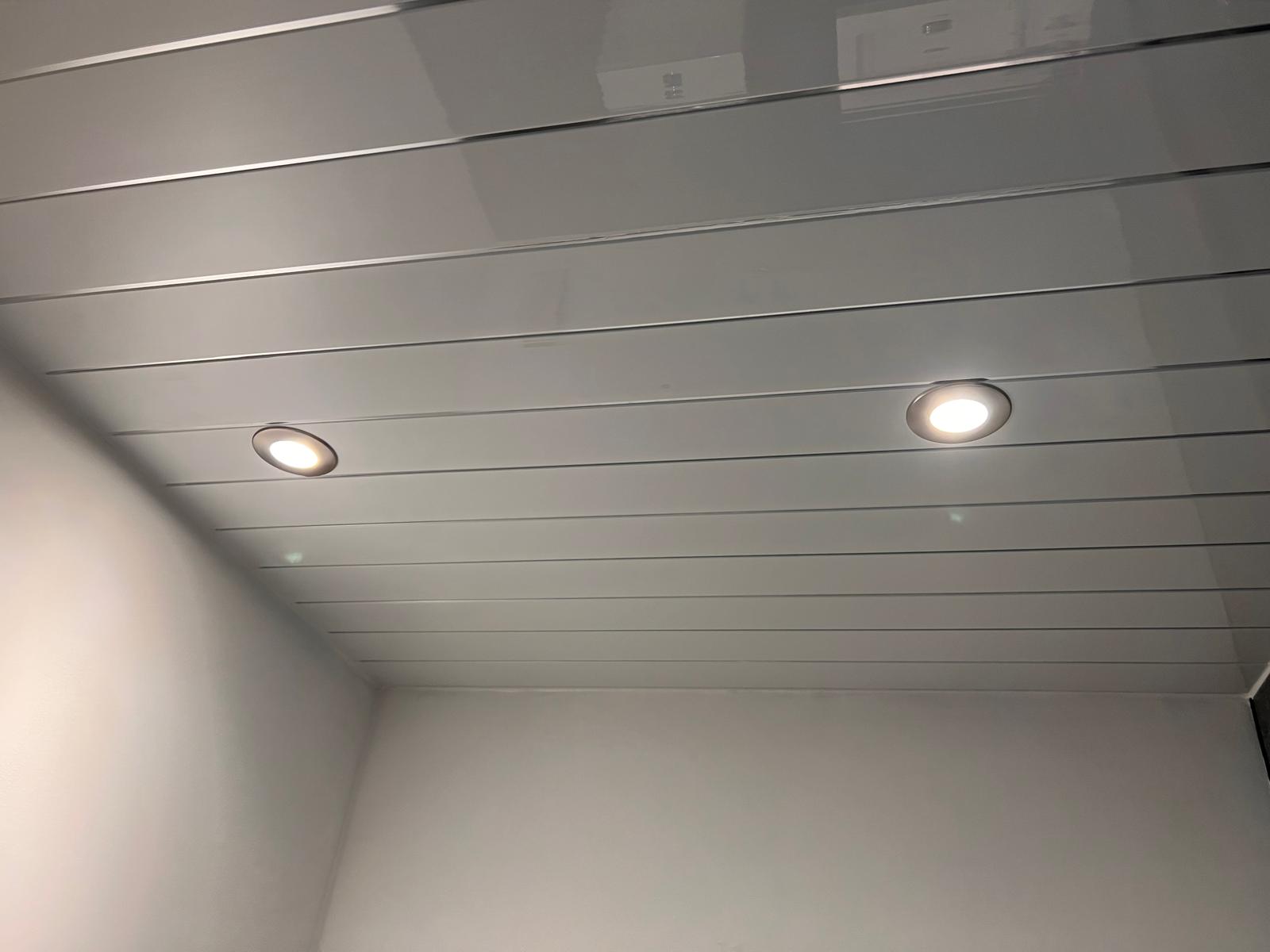 A serene indoor setting, dominated by a pristine white ceiling adorned with horizontal lines