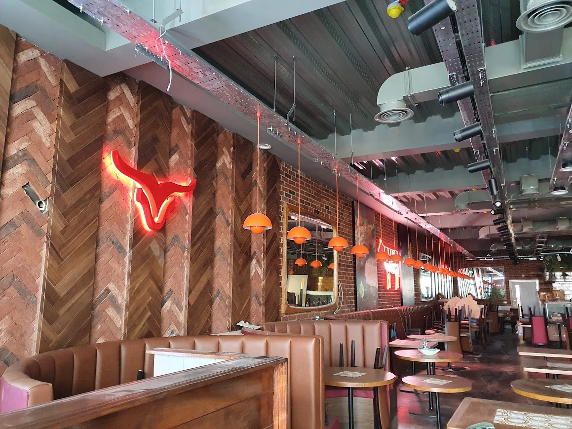 A lively scene at a restaurant named "Bullseye"